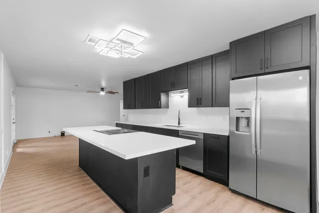 a kitchen with stainless steel appliances a refrigerator and a sink