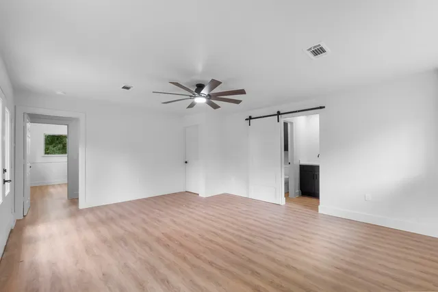 a view of empty room with wooden floor