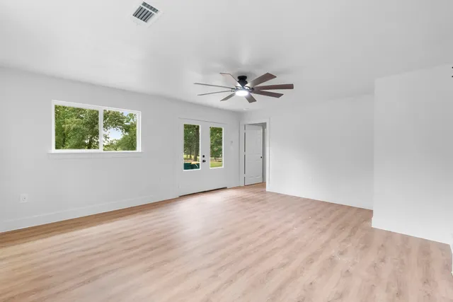 wooden floor in an empty room with a window