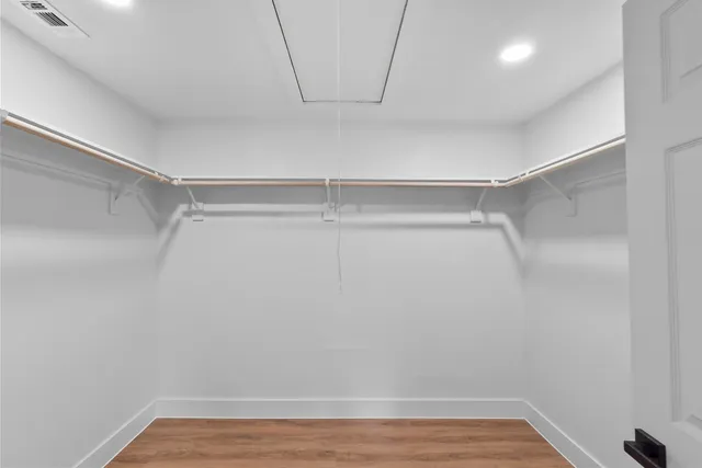 a view of a room with wooden floor