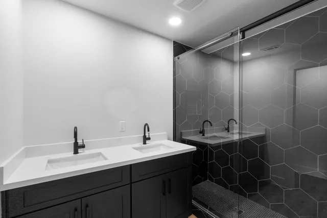 a bathroom with a double vanity sink and a mirror