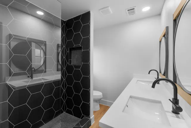 a bathroom with a sink toilet and shower