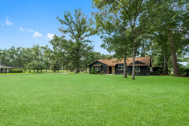 a front view of a house with a garden