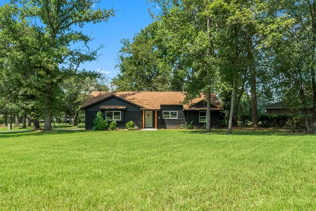 a front view of a house with a garden