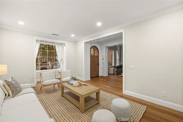 a dining room with furniture a chandelier and wooden floor