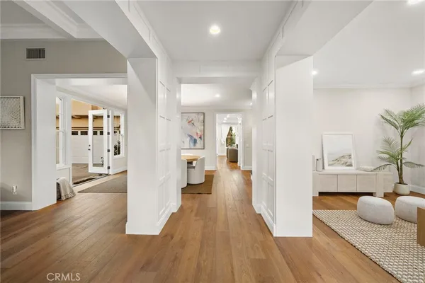 a living room with furniture kitchen view and a potted plant