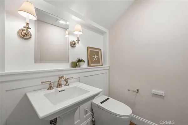 a spacious bathroom with a double vanity sink a mirror a window and a bathtub
