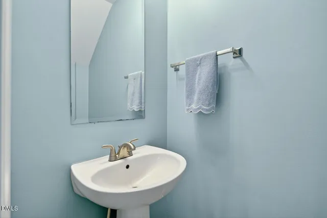 a bathroom with a sink and mirror