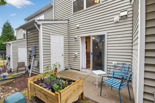 a view of a chairs and table in the backyard