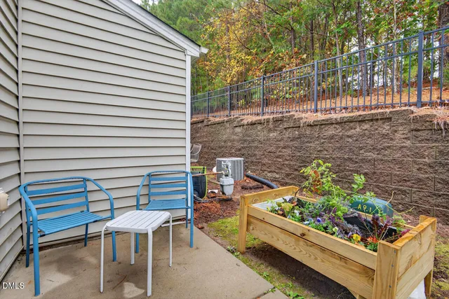 a view of a chairs and table in the backyard