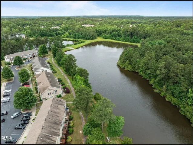 a view of a lake with a yard and mountain view in back