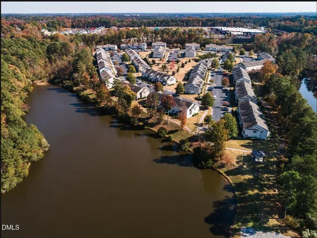 an aerial view of a house with a lake view