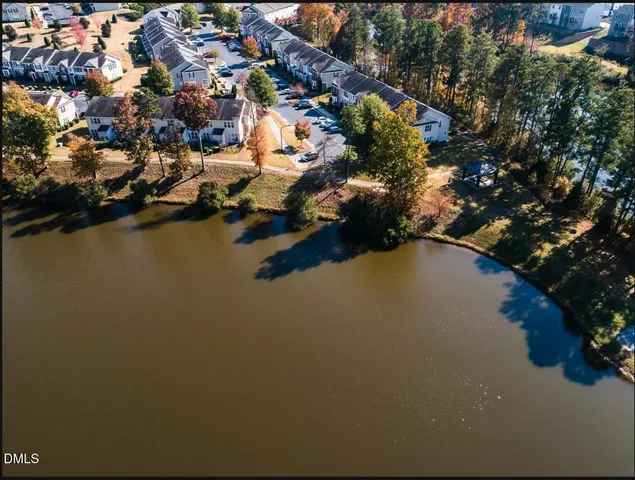 an aerial view of house with yard and lake view