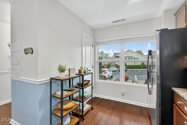 a view of a workspace with furniture and a window