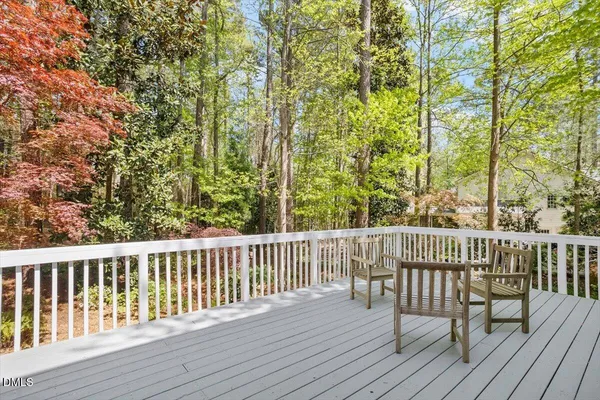 a view of balcony with wooden floor and fence