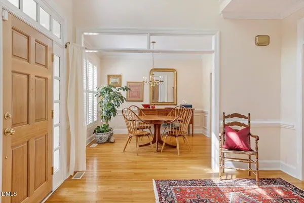 a dining room with furniture window and wooden floor