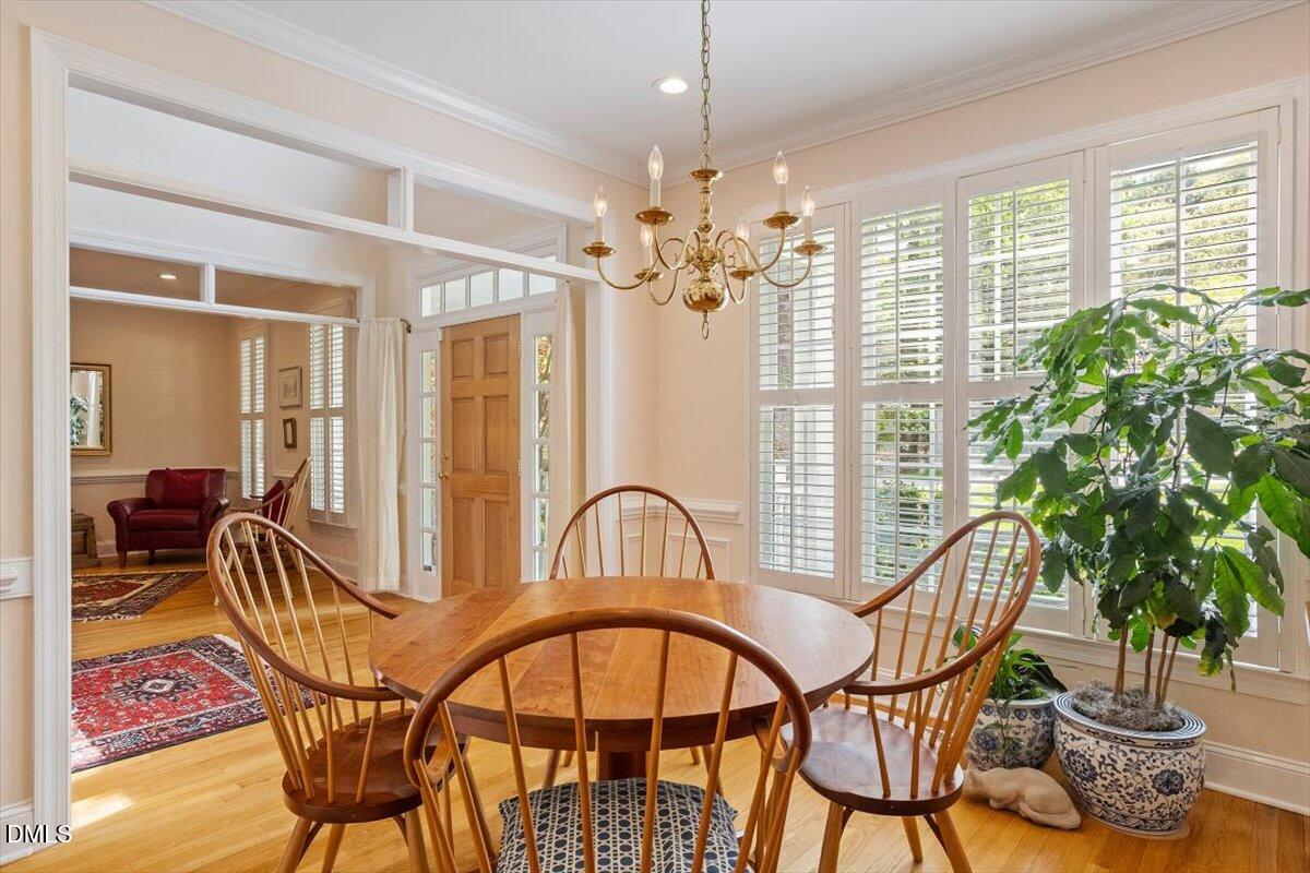 9108 Hometown Drive Raleigh, NC 27615 - Photo 16 of 41 a view of a dining room with furniture window and wooden floor