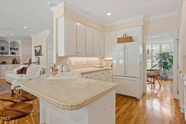 a stove top oven sitting inside of a kitchen