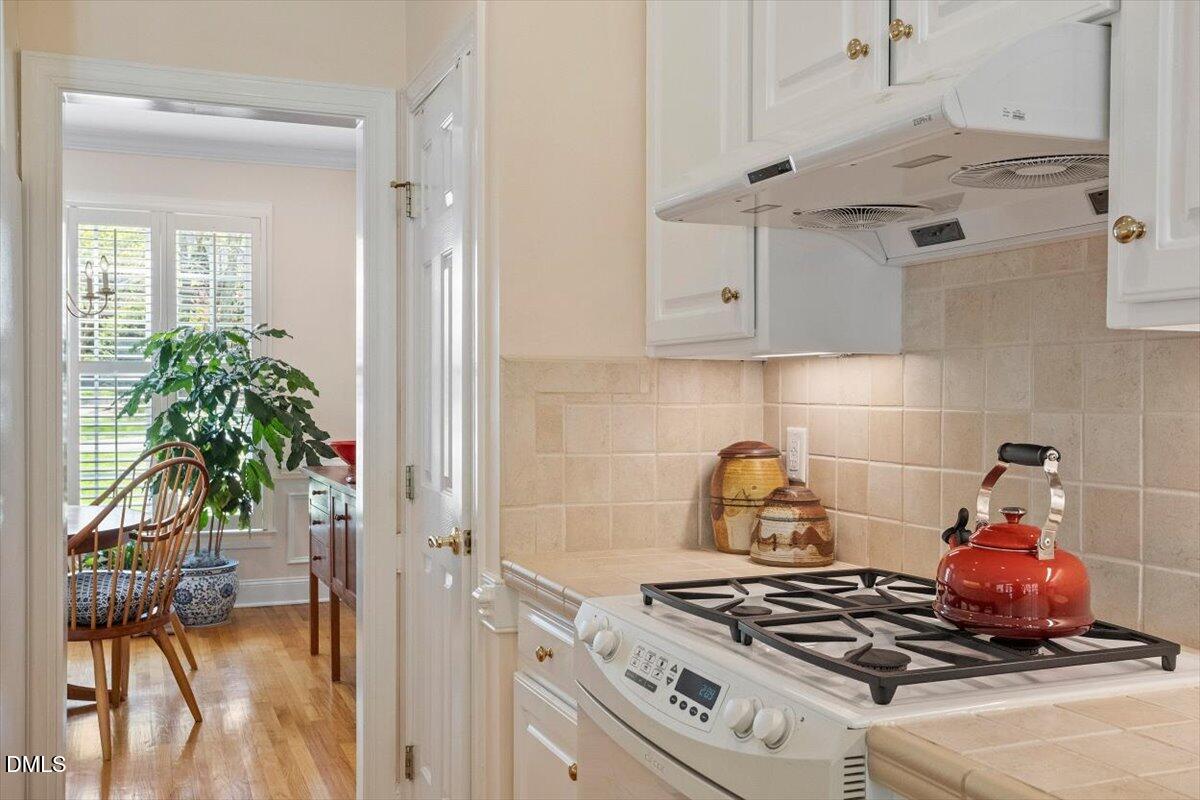 9108 Hometown Drive Raleigh, NC 27615 - Photo 24 of 41 a stove top oven sitting inside of a kitchen