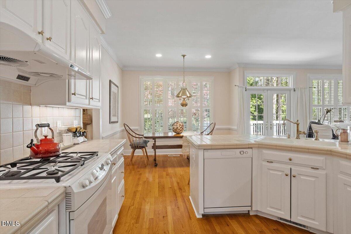 9108 Hometown Drive Raleigh, NC 27615 - Photo 25 of 41 a kitchen with a sink appliances and cabinets