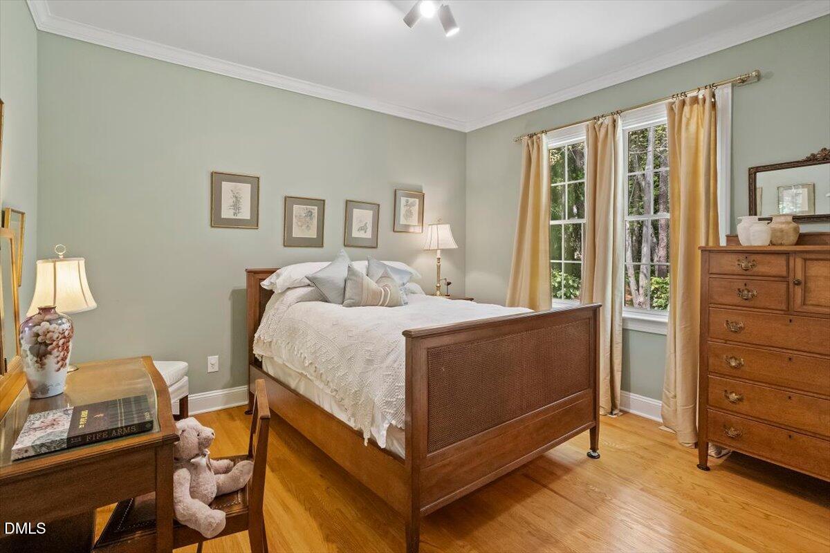 9108 Hometown Drive Raleigh, NC 27615 - Photo 27 of 41 a bedroom with a bed and wooden floor