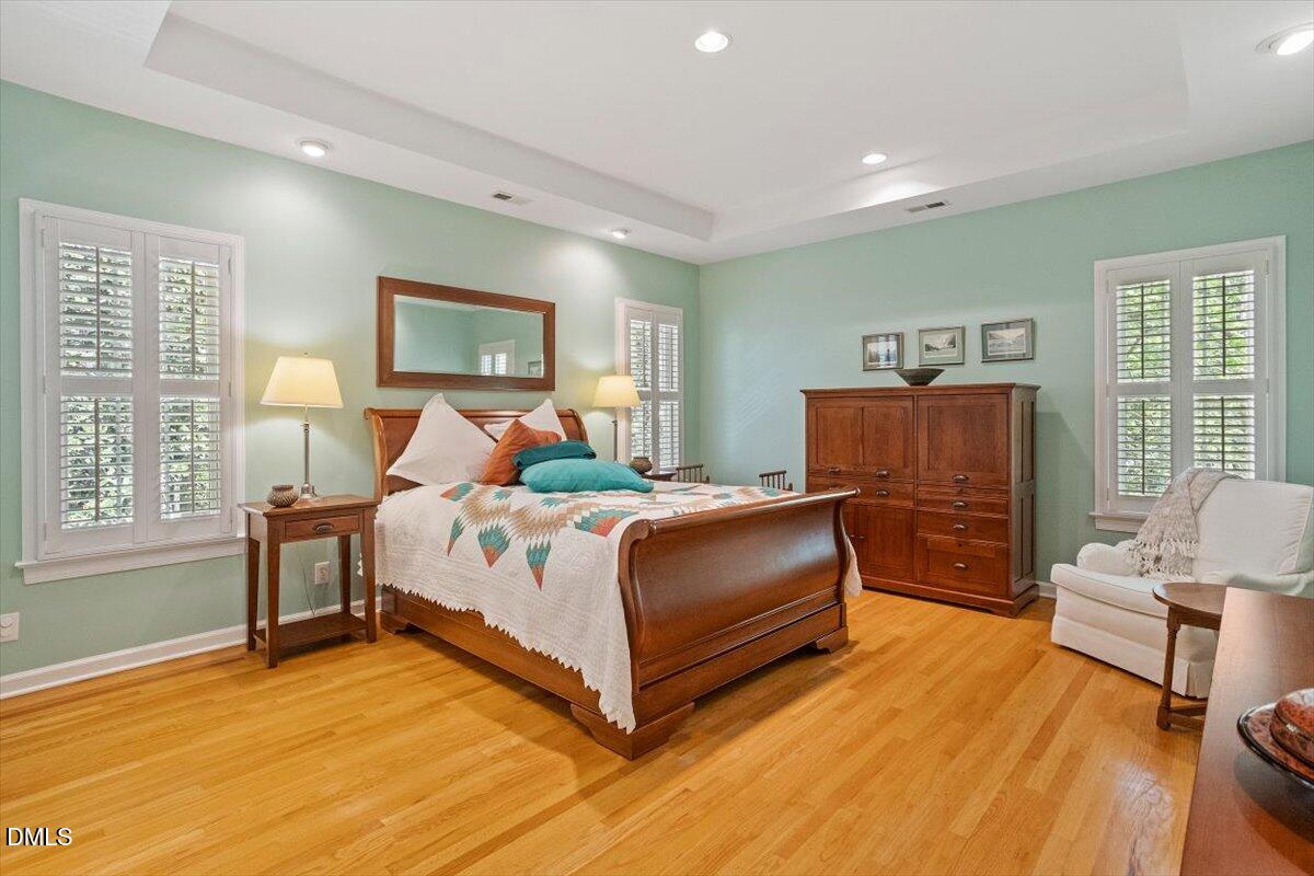 9108 Hometown Drive Raleigh, NC 27615 - Photo 33 of 41 a bedroom with a bed and wooden floor