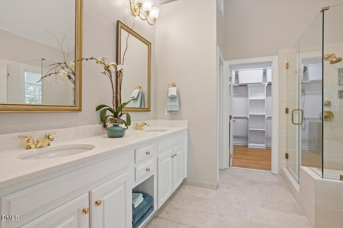 9108 Hometown Drive Raleigh, NC 27615 - Photo 35 of 41 a spacious bathroom with a shower sink and a mirror