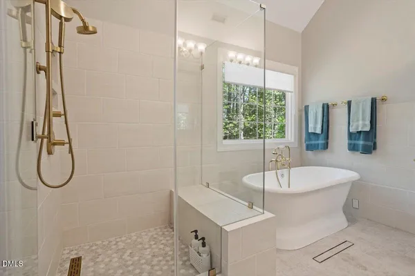 a bathroom with a double vanity sink toilet and shower