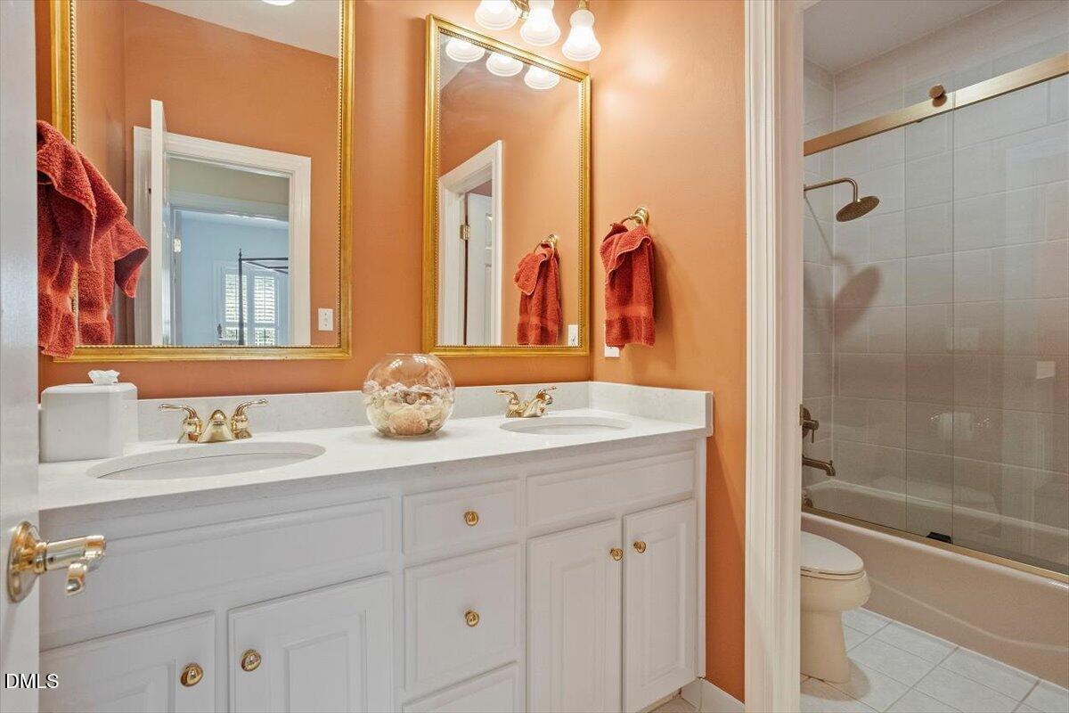 9108 Hometown Drive Raleigh, NC 27615 - Photo 38 of 41 a bathroom with a double vanity sink toilet and shower