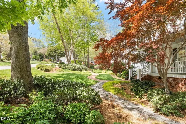 a view of backyard of house with green space