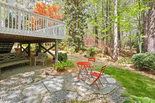 a backyard of a house with a yard and outdoor seating