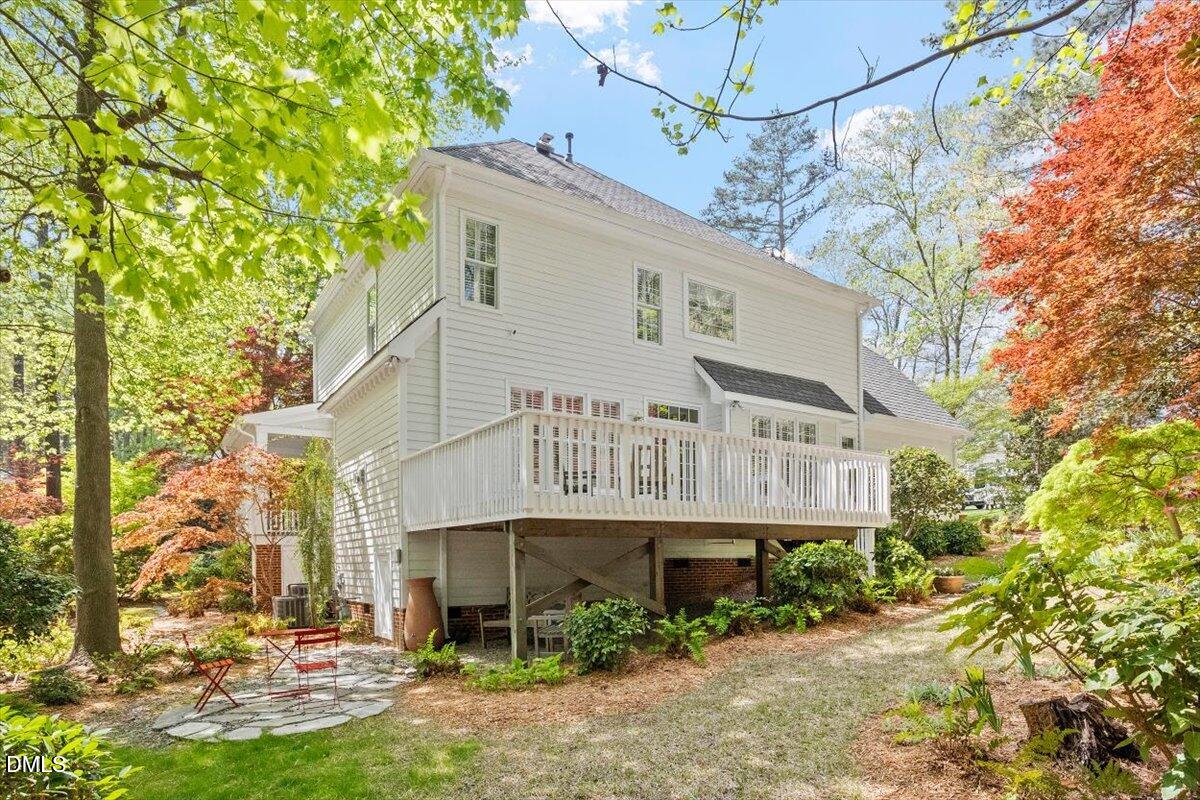 9108 Hometown Drive Raleigh, NC 27615 - Photo 9 of 41 a view of a big house with plants and large trees