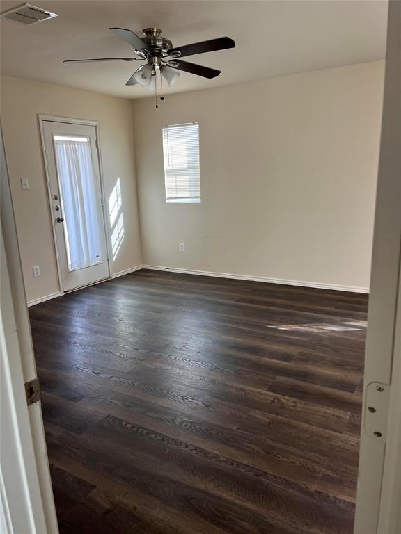 10548 Flagstaff Run Fort Worth, TX 76140 - Photo 18 of 20 an empty room with wooden floor fan and windows
