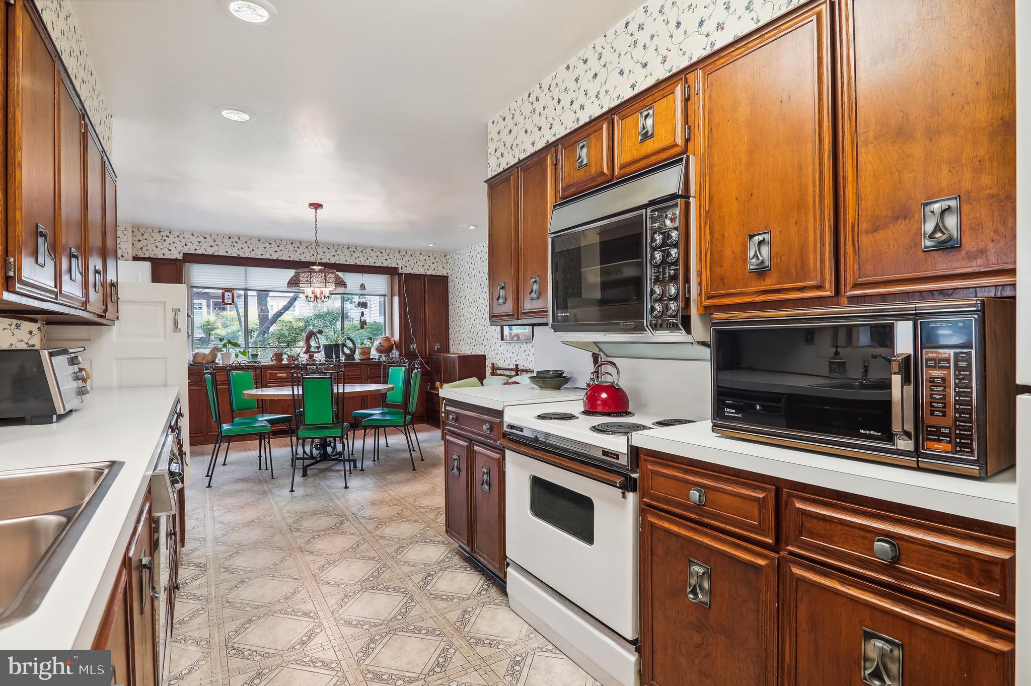 122 St Lawrence Drive Silver Spring, MD 20901 - Photo 7 of 9 a kitchen with stainless steel appliances a stove a sink and a microwave