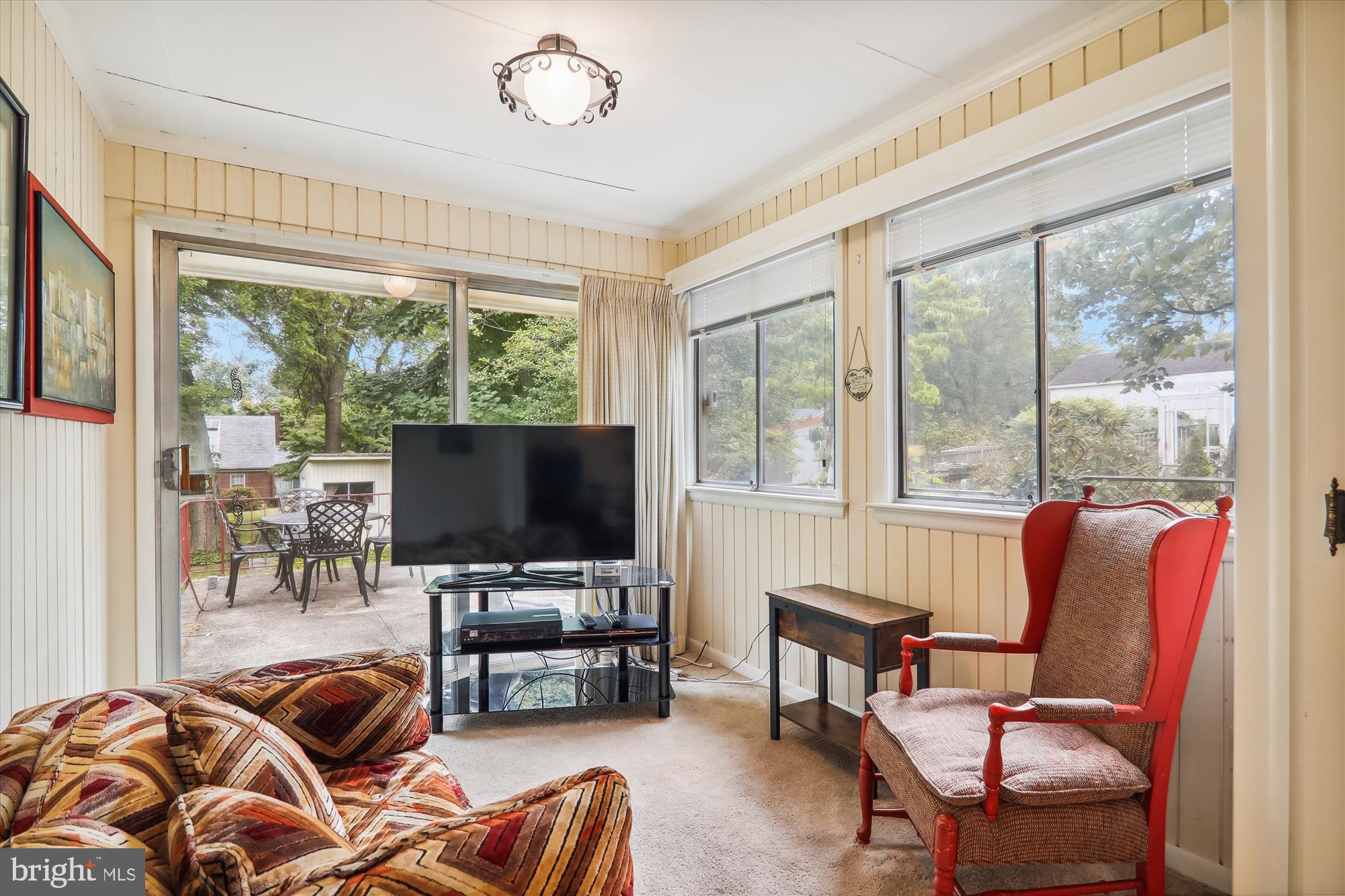 122 St Lawrence Drive Silver Spring, MD 20901 - Photo 8 of 9 a living room with furniture a flat screen tv and a large window