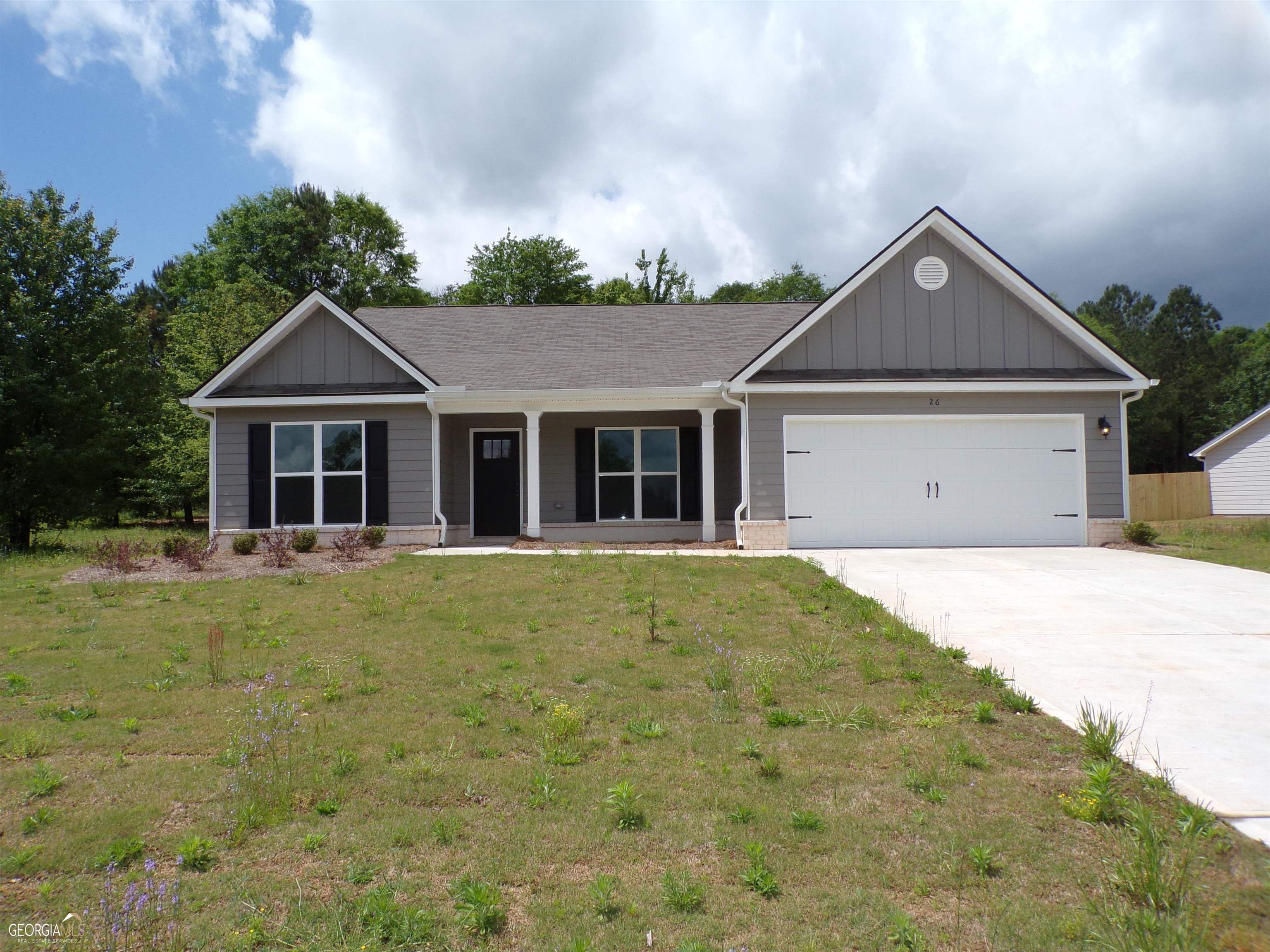 91 Suwannee Way, Unit 262 Jefferson, GA 30549 - Photo 1 of 1 a front view of a house with a garden and yard