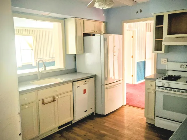 a kitchen with a refrigerator stove and sink