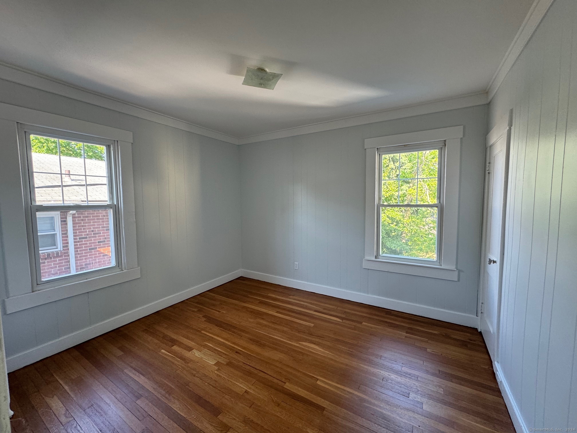 1253 Forest Road, Unit 2 New Haven, CT 06515 - Photo 26 of 30 an empty room with wooden floor and windows