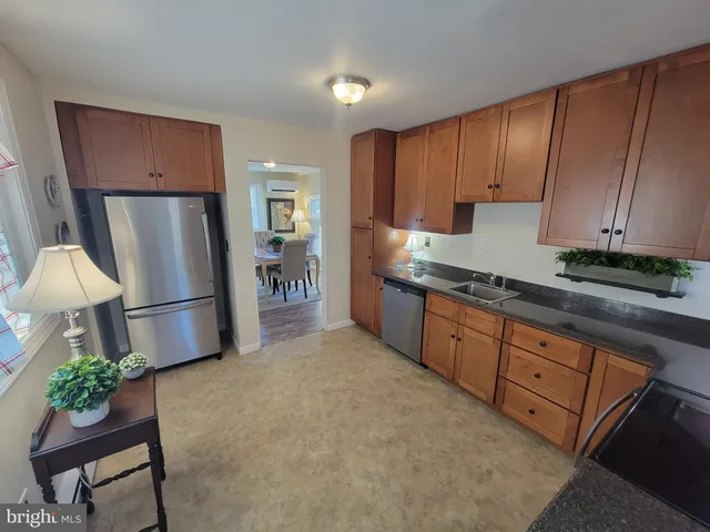 a kitchen with stainless steel appliances granite countertop a refrigerator sink and cabinets