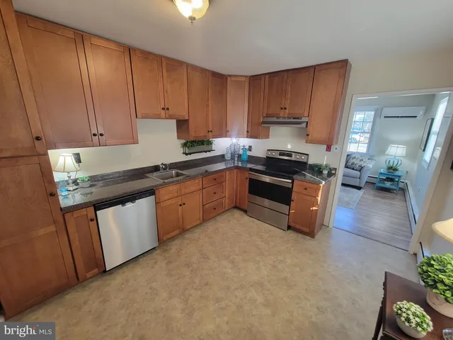 a kitchen with stainless steel appliances granite countertop a stove a sink dishwasher and a refrigerator