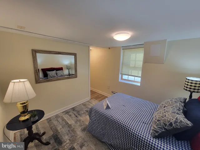 a bedroom with a bed and a lamp on table