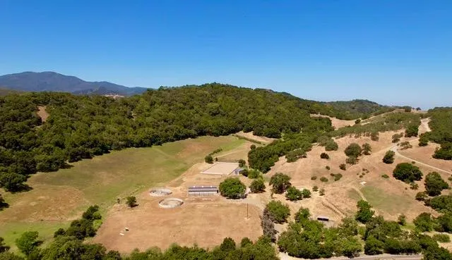 a view of a field with a mountain in the background