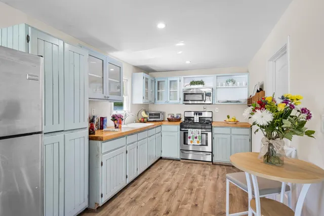 a kitchen that has a lot of cabinets a sink and a stove in it