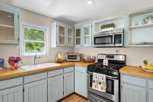 a kitchen with a sink stove and microwave