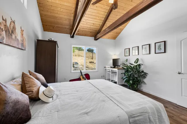 a bedroom with a bed and a potted plant