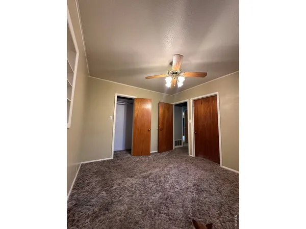 a view of an empty room with a chandelier