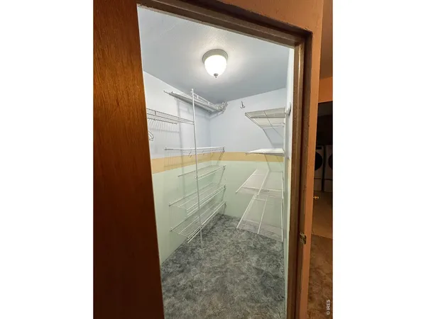 a view of a hallway with washer and dryer