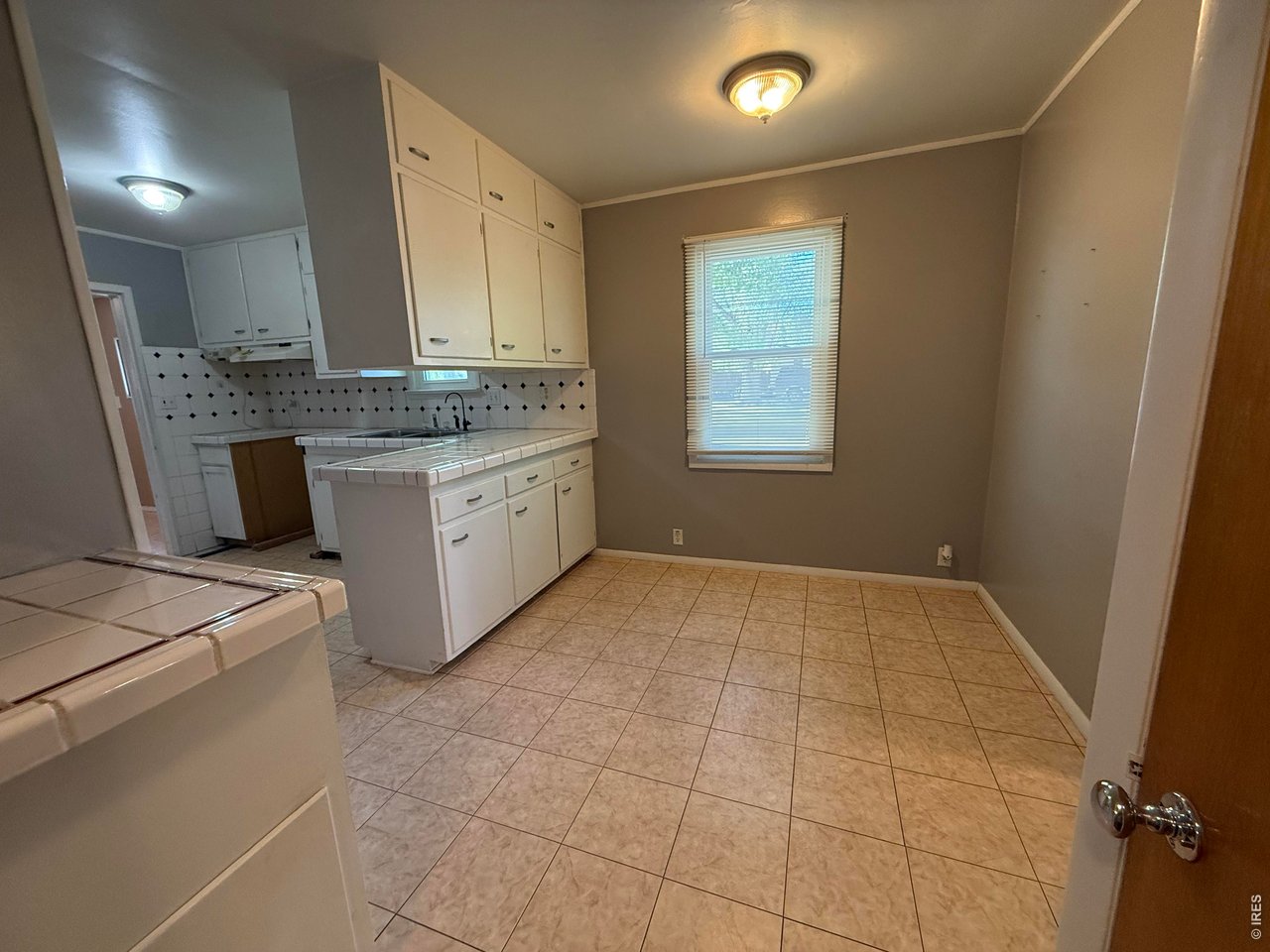 711 South 3rd Street Lamar, CO 81052 - Photo 5 of 30 a bathroom with a sink a vanity and mirror