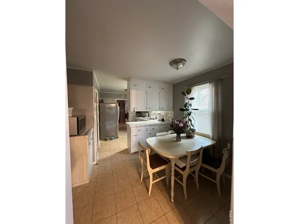 a view of a dining room with furniture and window