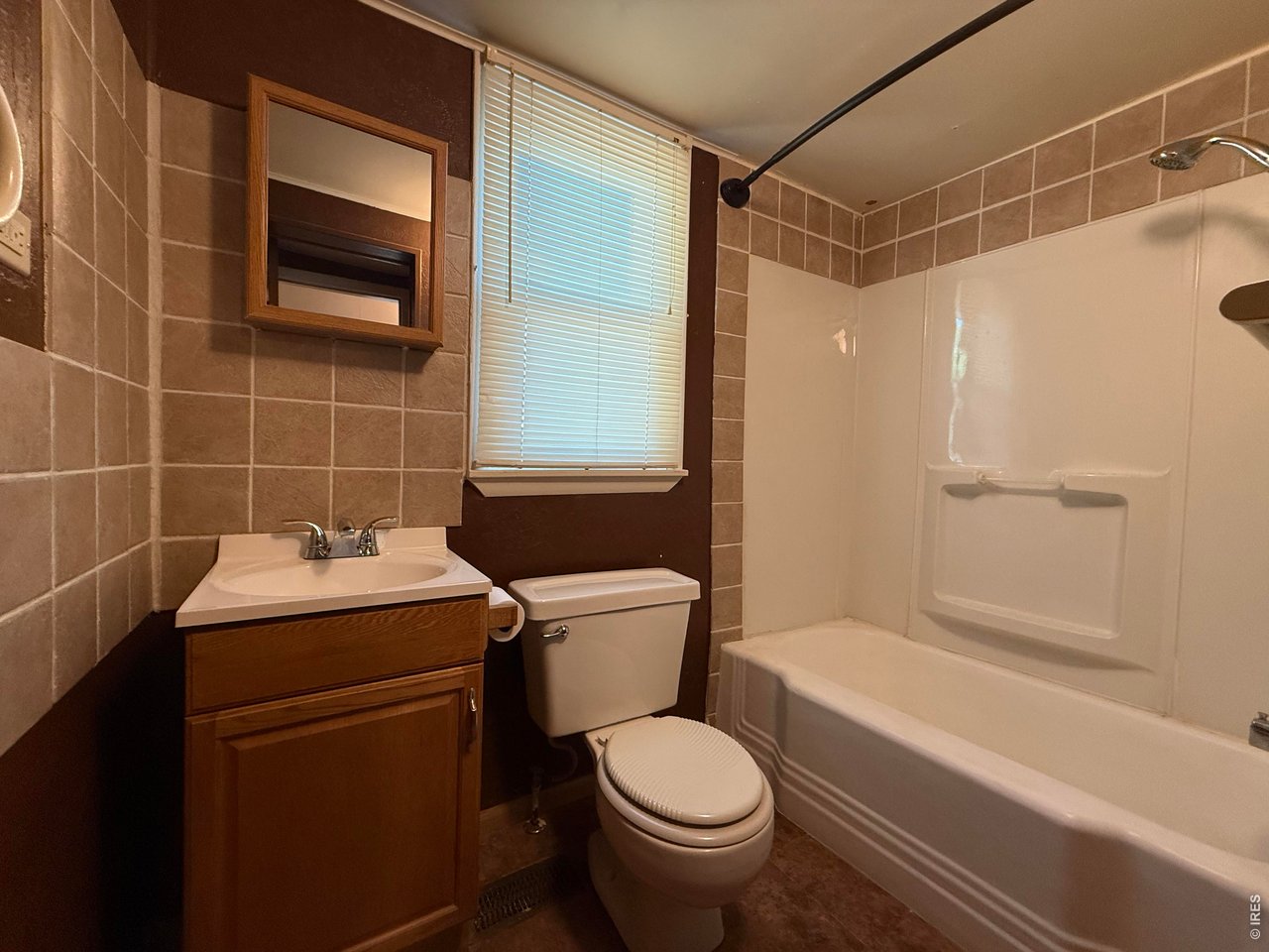 711 South 3rd Street Lamar, CO 81052 - Photo 10 of 30 a bathroom with a sink toilet and shower